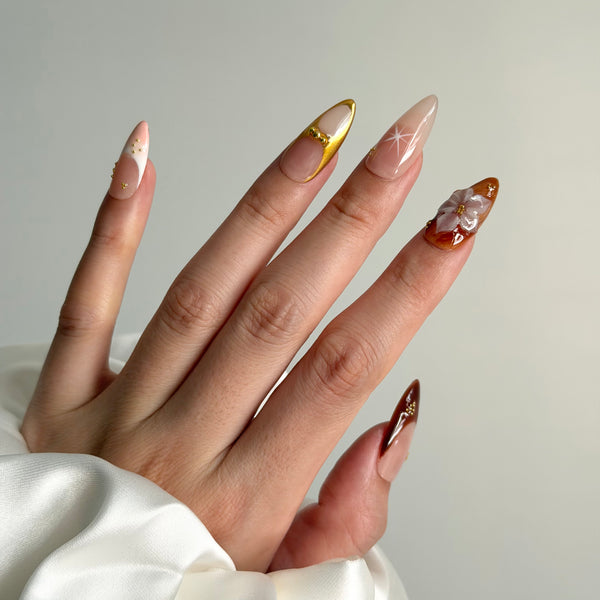 nude amber press on nails almond glossy gold detail floral design elegant evening style