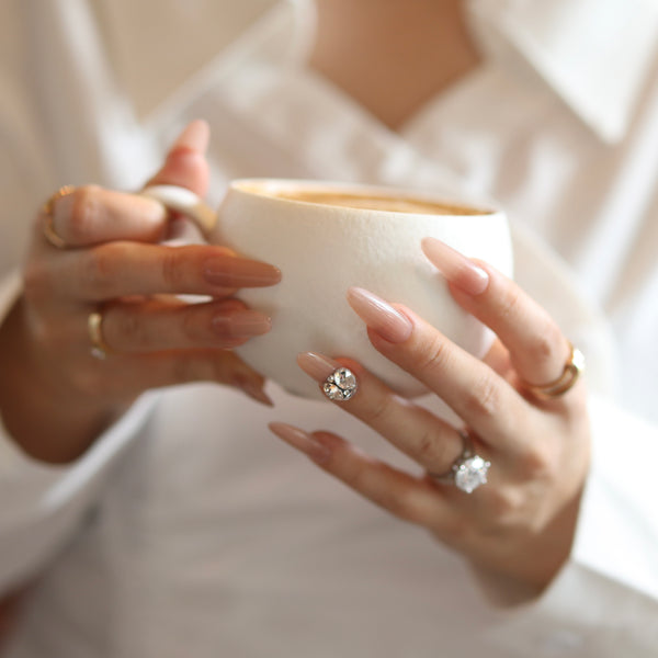 Glossy nude pink press-on nails almond shape minimalist luxury coffee date manicure