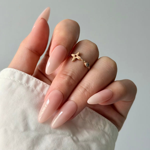 Soft nude almond press-on nails glossy finish elegant bridal party nail design