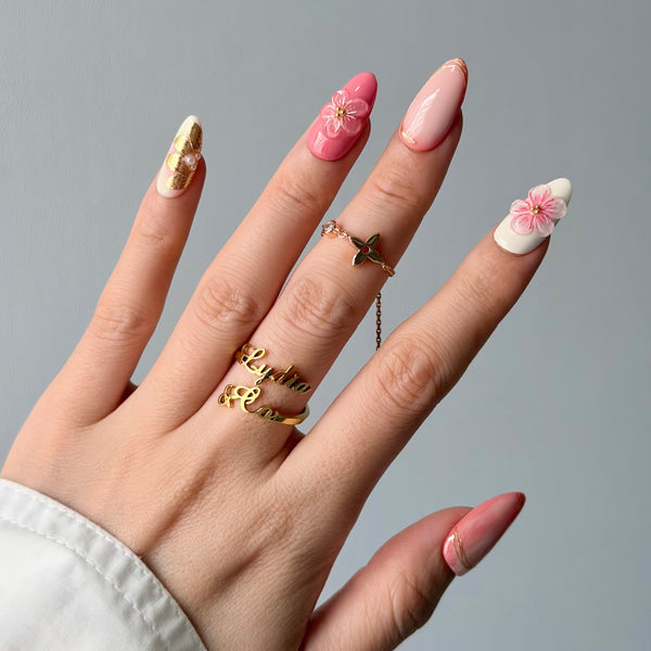 Glossy pink press-on nails almond shape floral gold design elegant party manicure